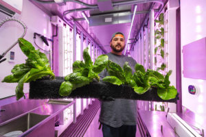 Hydroponics Container Farm Manager Holding a Soil Strip